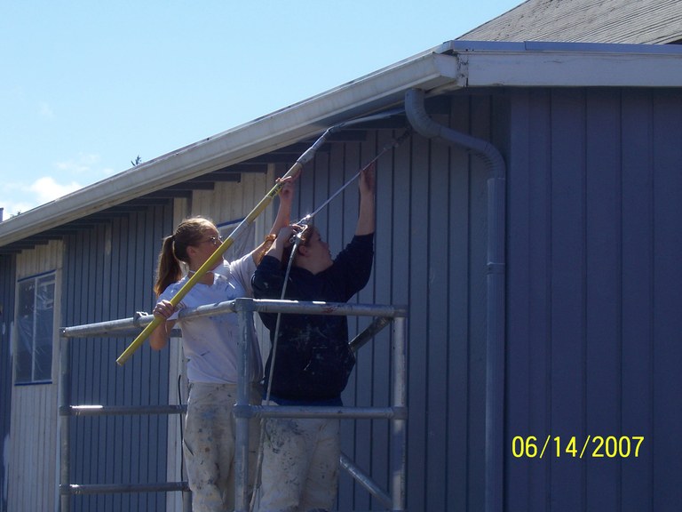 Job Corps. students painting side of library!